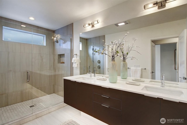 bathroom featuring a shower stall, tile patterned floors, and double vanity