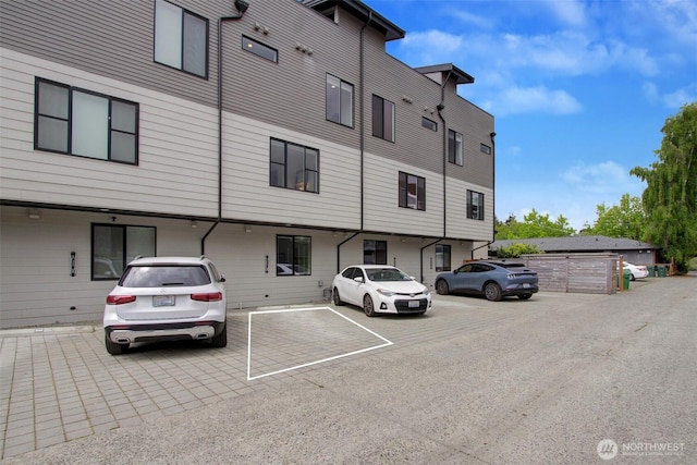 view of property featuring uncovered parking