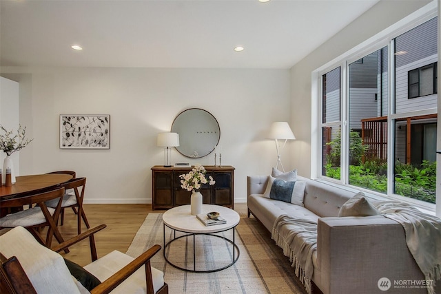 living room with wood finished floors, recessed lighting, and baseboards