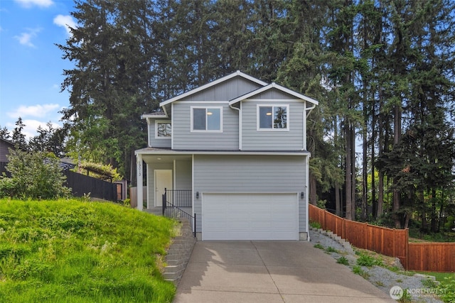 19013 63rd St E, Lake Tapps, WA 98391 - view of front facade with a garage, fence, concrete driveway, and board and batten siding