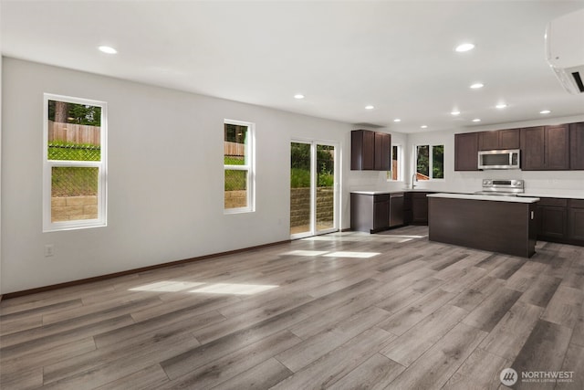 19013 63rd St E, Lake Tapps, WA 98391 - kitchen with stainless steel appliances, plenty of natural light, recessed lighting, and dark brown cabinets