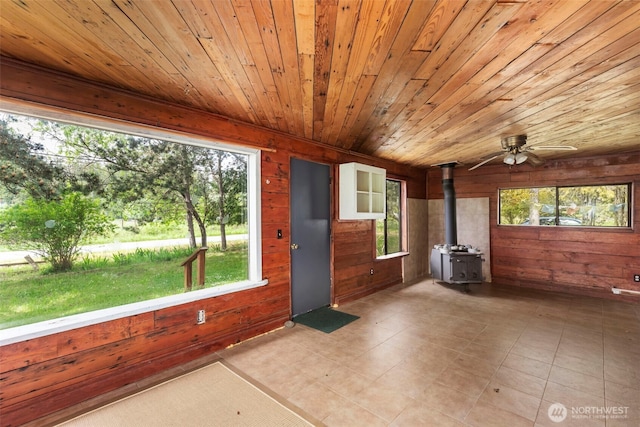 660 Schwartz Rd, Nordland, WA 98358 - unfurnished sunroom with a wood stove and plenty of natural light