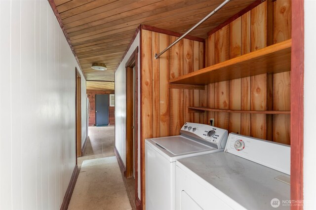 660 Schwartz Rd, Nordland, WA 98358 - laundry area featuring separate washer and dryer, wooden walls, wooden ceiling, and baseboards