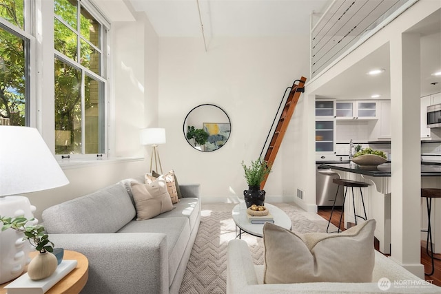 living area with baseboards and recessed lighting