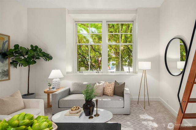 carpeted living room featuring baseboards