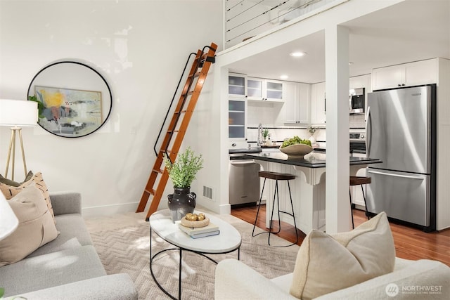 living room with recessed lighting, wood finished floors, and baseboards
