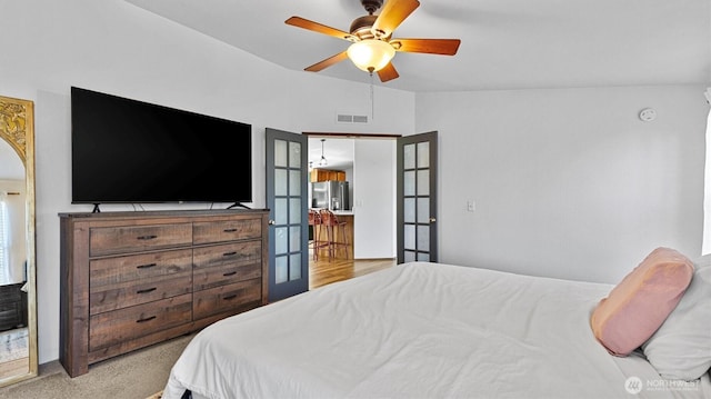 9904 237th Street Ct E, Graham, WA 98338 - bedroom featuring stainless steel refrigerator with ice dispenser, french doors, vaulted ceiling, and a ceiling fan