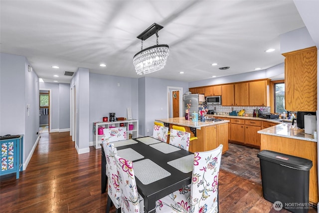 801 Bender Pl, Lynden, WA 98264 - dining room featuring healthy amount of natural light, dark wood-style floors, recessed lighting, a chandelier, and baseboards