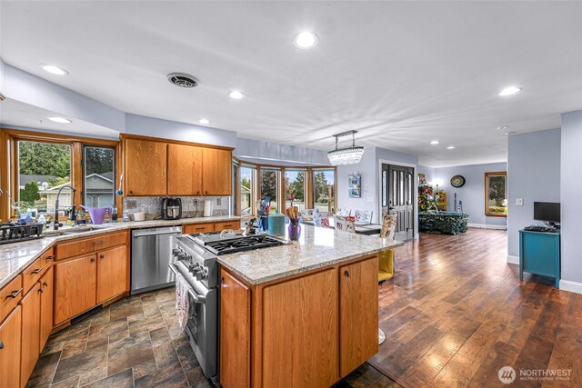 801 Bender Pl, Lynden, WA 98264 - kitchen featuring stainless steel appliances, a sink, recessed lighting, a center island, and light stone counters
