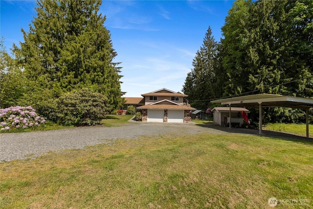 9320 96th St NE, Arlington, WA 98223 - view of front facade with a front yard, a carport, driveway, and a garage