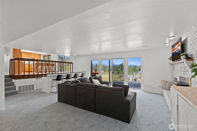 9320 96th St NE, Arlington, WA 98223 - living area featuring light colored carpet, a fireplace, and stairway