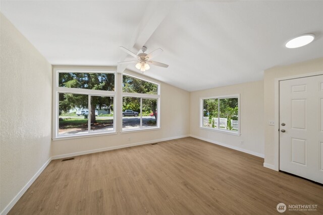 empty room with wood finished floors, ceiling fan, and baseboards