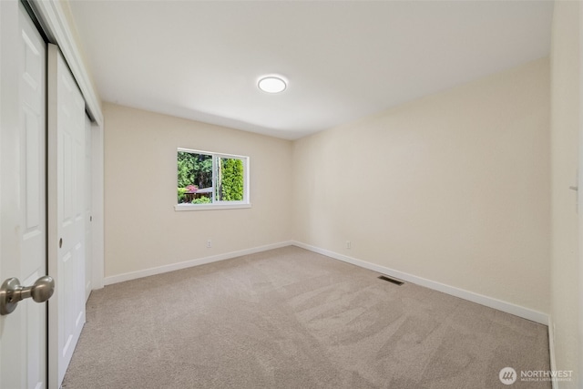 unfurnished bedroom with a closet, carpet, and baseboards