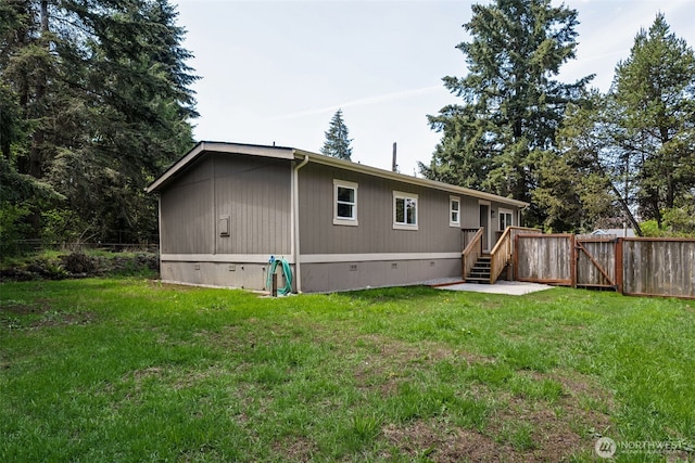 rear view of property featuring crawl space and a gate