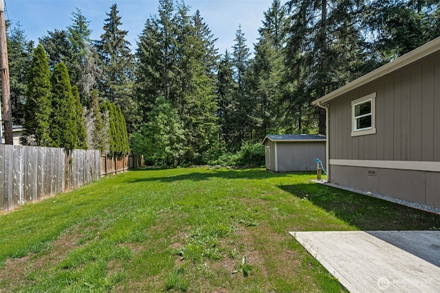 view of yard featuring a shed and an outdoor structure