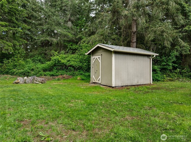 view of shed featuring a wooded view