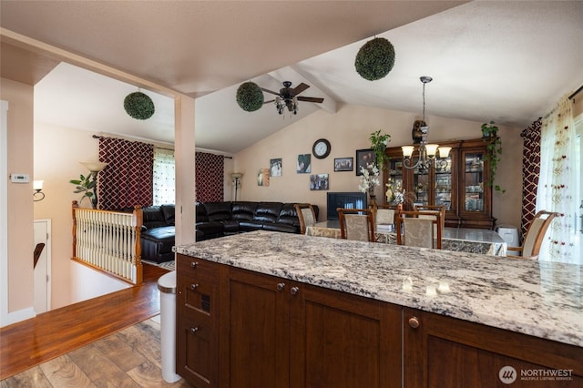 2809 E Sunset, Bellingham, WA 98226 - kitchen featuring wood finished floors, vaulted ceiling, a chandelier, open floor plan, and light stone countertops