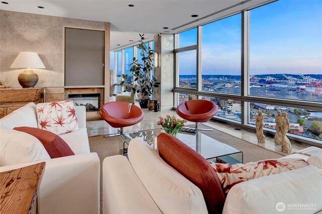 715 2nd Ave Unit 1801, Seattle, WA 98104 - living area featuring floor to ceiling windows, a fireplace, a water view, and a view of city