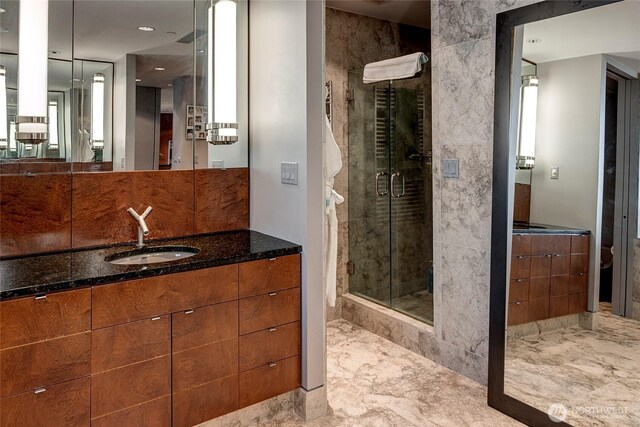 715 2nd Ave Unit 1801, Seattle, WA 98104 - full bathroom featuring marble finish flooring, a stall shower, and vanity