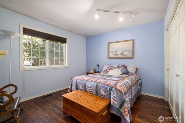 987 NW Camano Dr, Camano Island, WA 98282 - bedroom with hardwood / wood-style flooring, rail lighting, a closet, and baseboards