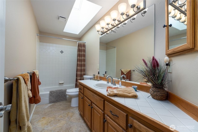 987 NW Camano Dr, Camano Island, WA 98282 - full bath featuring a skylight, toilet, vanity, and shower / bathtub combination with curtain