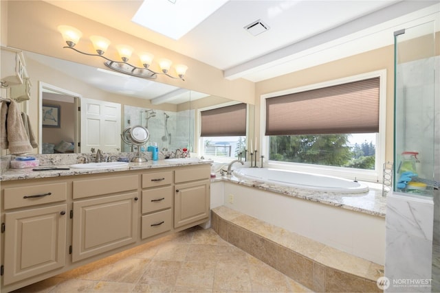 987 NW Camano Dr, Camano Island, WA 98282 - ensuite bathroom featuring a shower stall, vanity, a bath, and a skylight