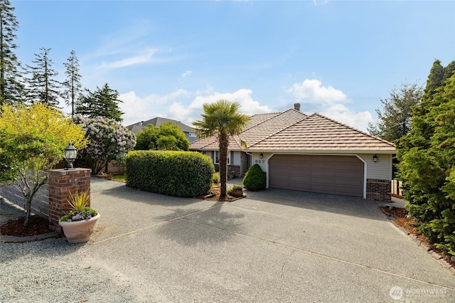 987 NW Camano Dr, Camano Island, WA 98282 - view of front facade with brick siding, a garage, and concrete driveway
