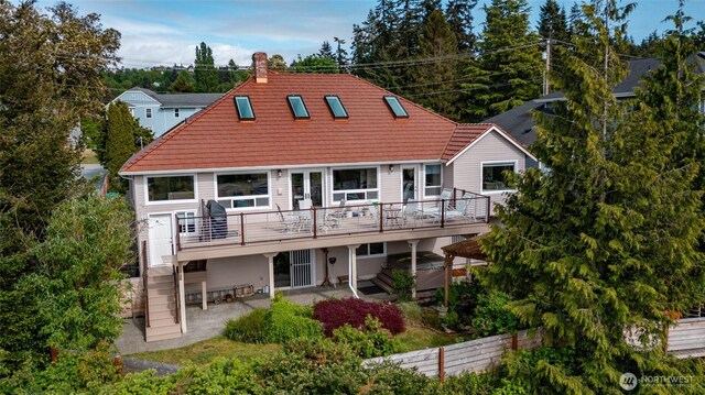 987 NW Camano Dr, Camano Island, WA 98282 - back of property with a hot tub, a patio, a chimney, a deck, and stairs