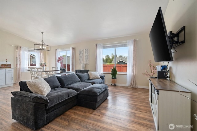 61 Patriot Way, Sequim, WA 98382 - living room with a chandelier, wood finished floors, vaulted ceiling, and baseboards
