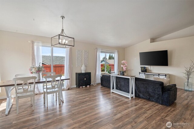 61 Patriot Way, Sequim, WA 98382 - dining area featuring lofted ceiling, wood finished floors, a chandelier, and baseboards