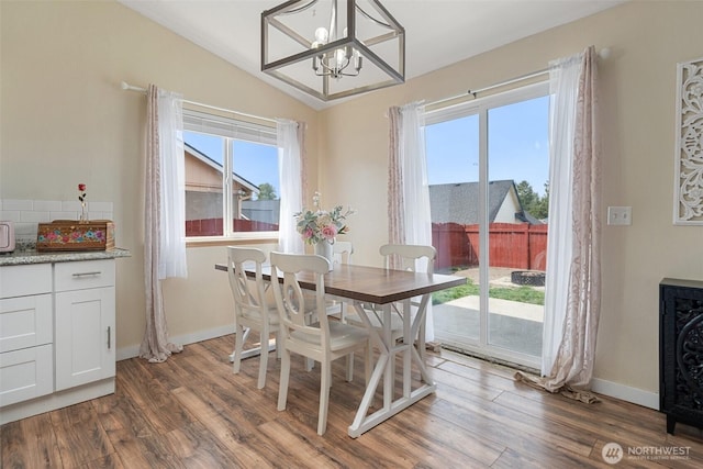 61 Patriot Way, Sequim, WA 98382 - dining area featuring a chandelier, plenty of natural light, dark wood-type flooring, vaulted ceiling, and baseboards