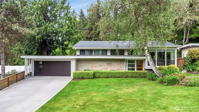 view of front facade with a garage, stone siding, concrete driveway, and a front yard