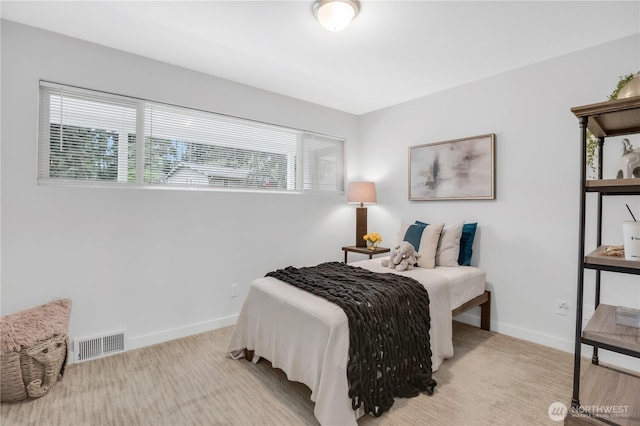 bedroom featuring multiple windows, baseboards, and carpet floors