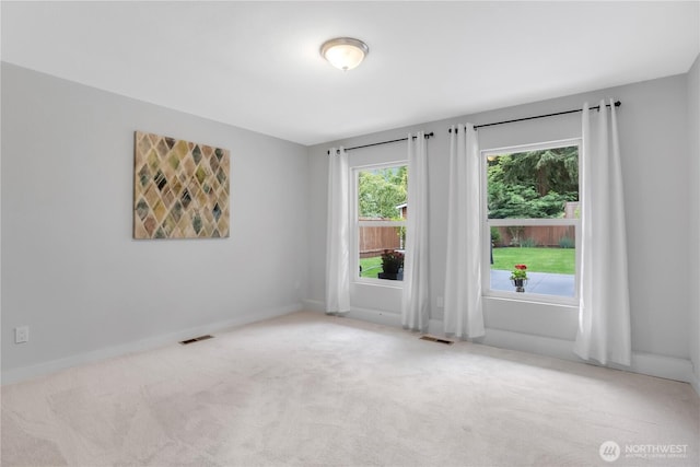 unfurnished room with carpet floors and baseboards