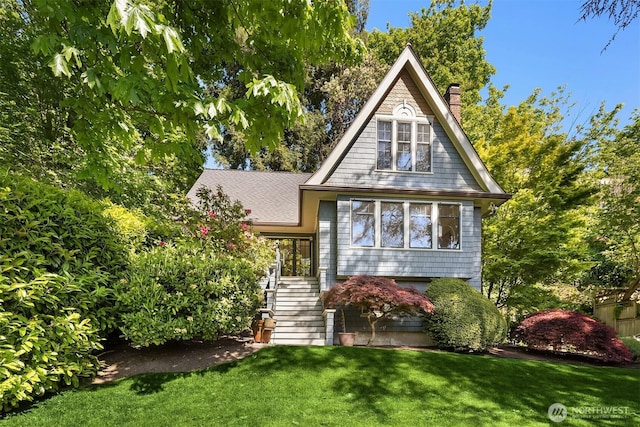 view of front of property featuring a chimney, a front lawn, and stairway