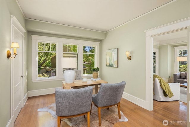 dining room with hardwood / wood-style floors, an office area, crown molding, baseboards, and healthy amount of natural light