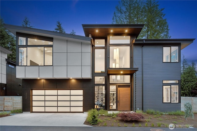 contemporary home featuring an attached garage and concrete driveway