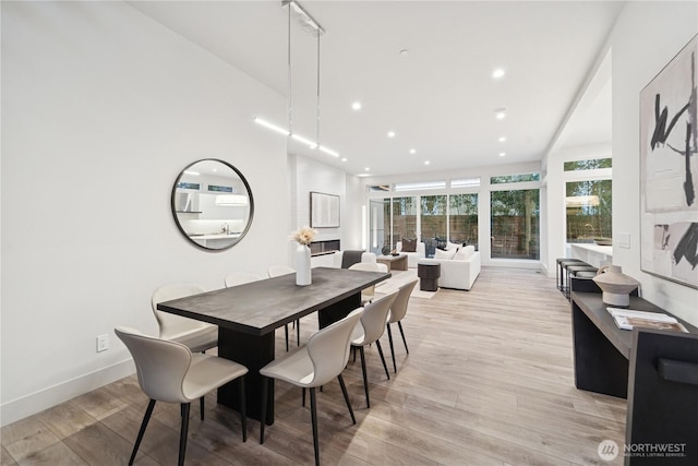 dining area featuring light wood-style floors, recessed lighting, and baseboards