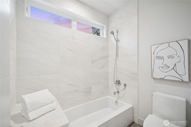 bathroom featuring bathing tub / shower combination and toilet