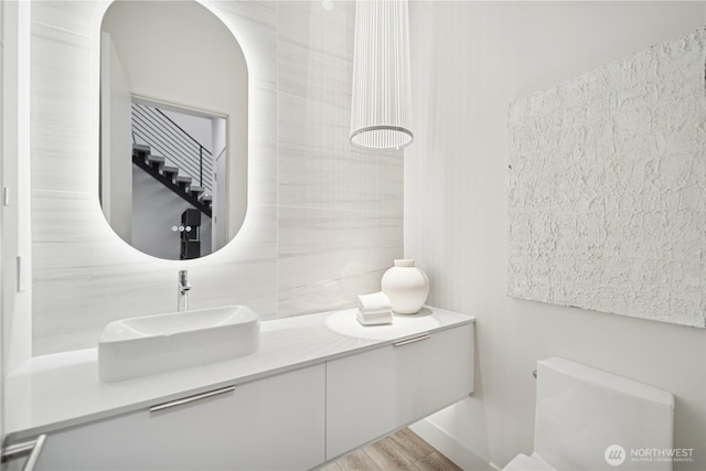 bathroom with a sink and wood finished floors