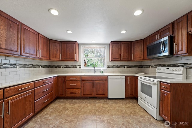 5207 NW Painted Hills Rd, Ephrata, WA 98823 - kitchen with white appliances, a sink, decorative backsplash, light countertops, and recessed lighting