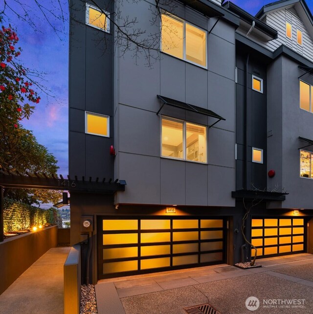 1416 6th Ave N, Seattle, WA 98109 - view of front of home with an attached garage and stucco siding