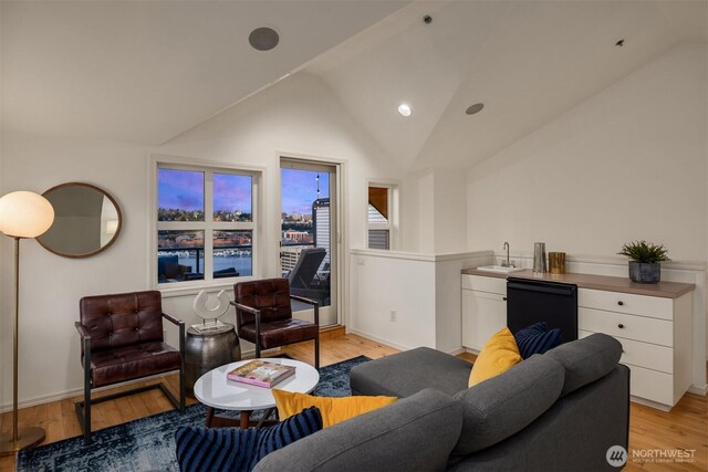 1416 6th Ave N, Seattle, WA 98109 - living area featuring vaulted ceiling, light wood-style flooring, and baseboards