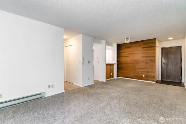 14650 NE 32nd St Unit A-13, Bellevue, WA 98007 - empty room with a baseboard heating unit, carpet floors, wooden walls, and a textured ceiling
