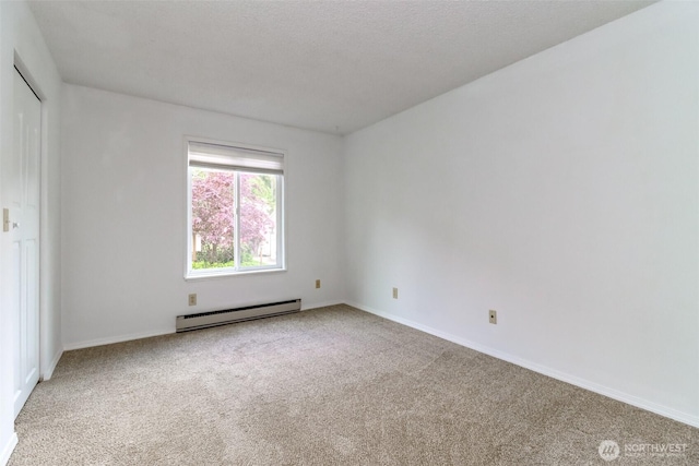 14650 NE 32nd St Unit A-13, Bellevue, WA 98007 - spare room with a baseboard radiator, carpet floors, and baseboards