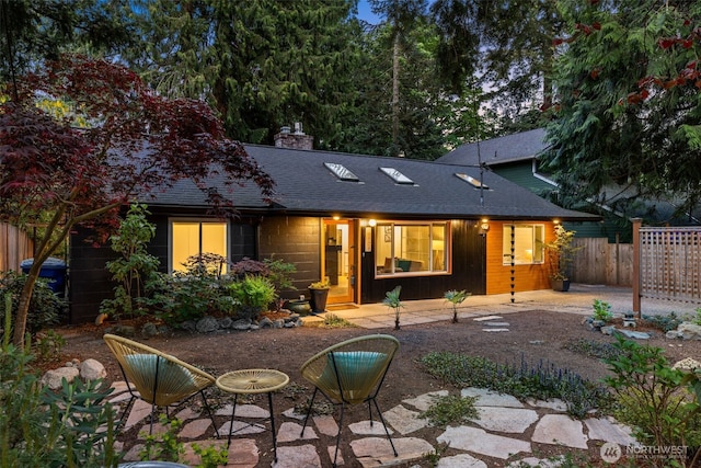 18906 32nd Ave NE, Lake Forest Park, WA 98155 - back of house featuring fence, a chimney, roof with shingles, and a patio