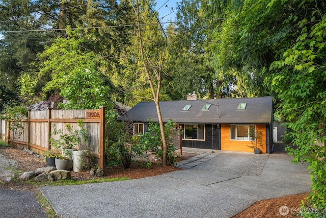 18906 32nd Ave NE, Lake Forest Park, WA 98155 - view of front of home featuring driveway, fence, a chimney, and a shingled roof