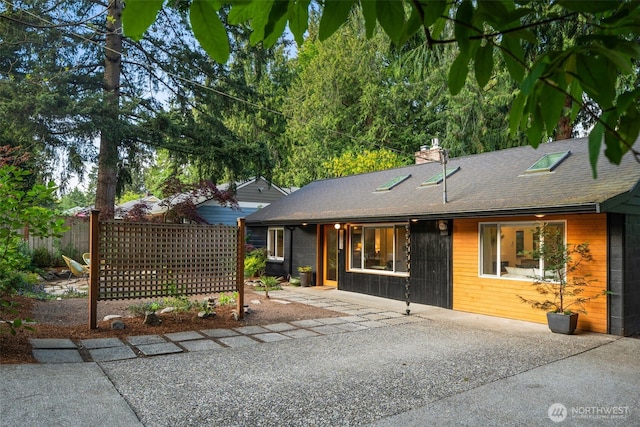 18906 32nd Ave NE, Lake Forest Park, WA 98155 - ranch-style home featuring fence, a patio, a chimney, and a shingled roof