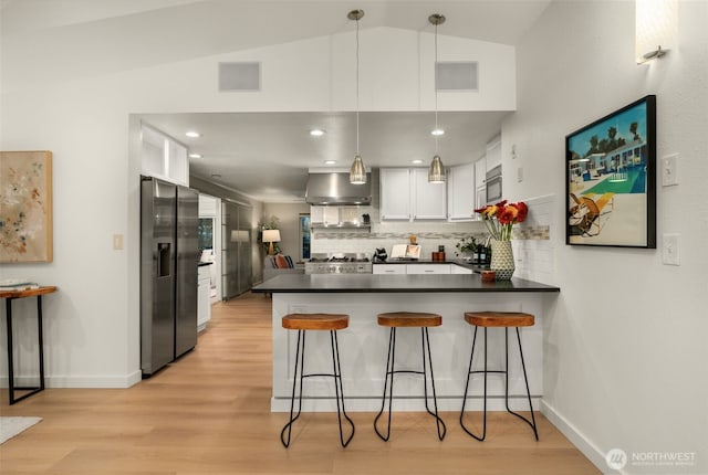 18906 32nd Ave NE, Lake Forest Park, WA 98155 - kitchen featuring a peninsula, stainless steel refrigerator with ice dispenser, dark countertops, wall chimney range hood, and decorative backsplash