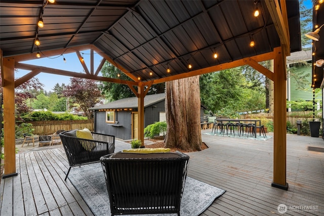 18906 32nd Ave NE, Lake Forest Park, WA 98155 - deck with outdoor dining area, an outdoor living space with a fire pit, a gazebo, and fence